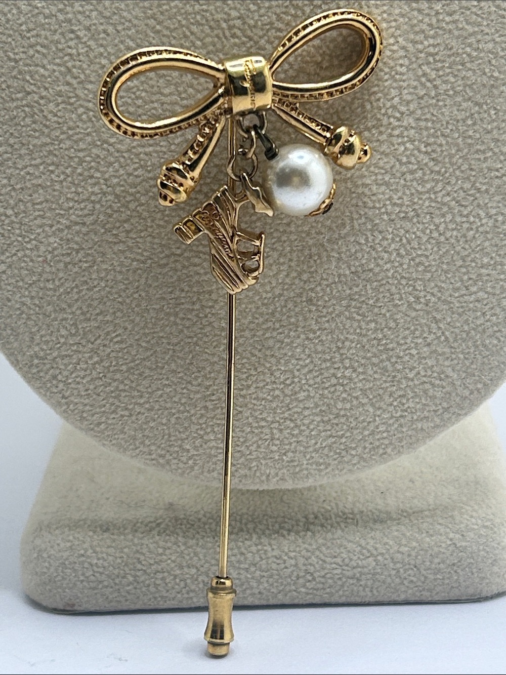 Salvatore Ferragamo Gold Bow Stick Pin with Pearl and Charms